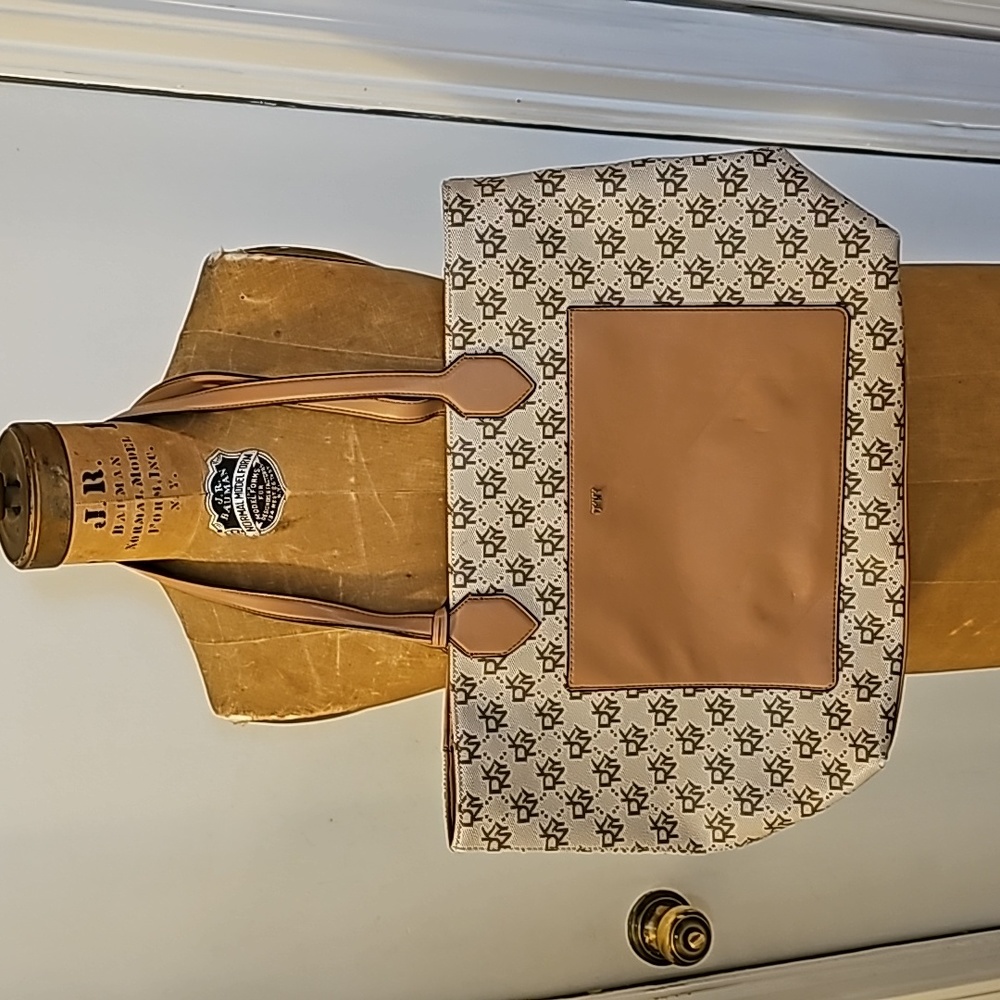 DKNY Vinyl Shoulder Purse. Creme and tan. Bag Charm. Multi Pocket. Zip closure.